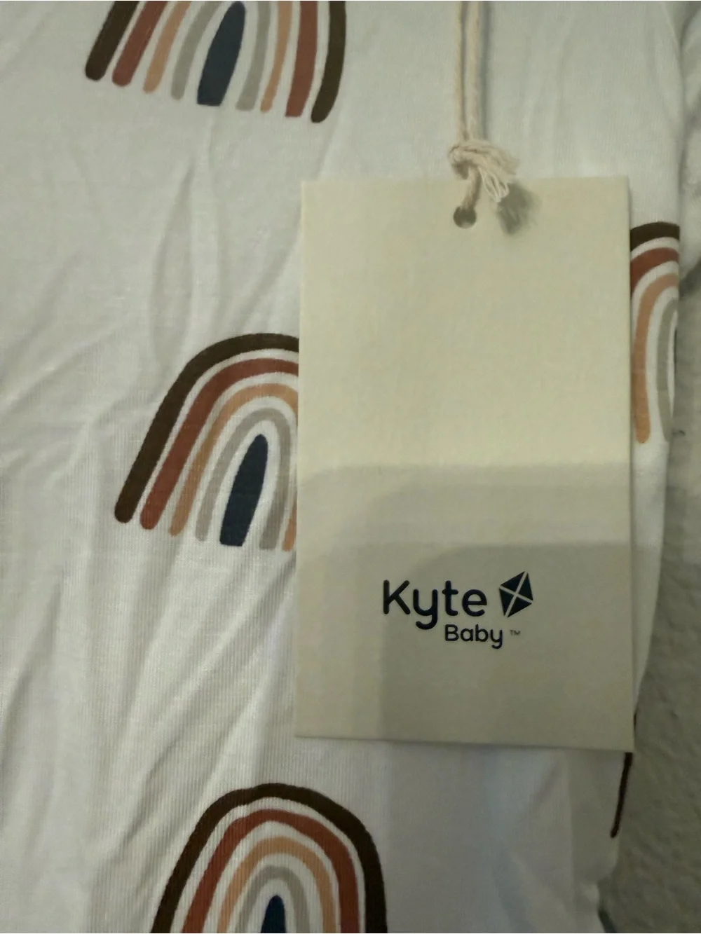 Kyte BABY Cream One-Piece with Brown Trim and Rainbow Print